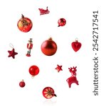 Christmas holliday red styled image, Christmas baubles in shape of a red decoration like snowflake, star and candy falling in the air isolated on white background.