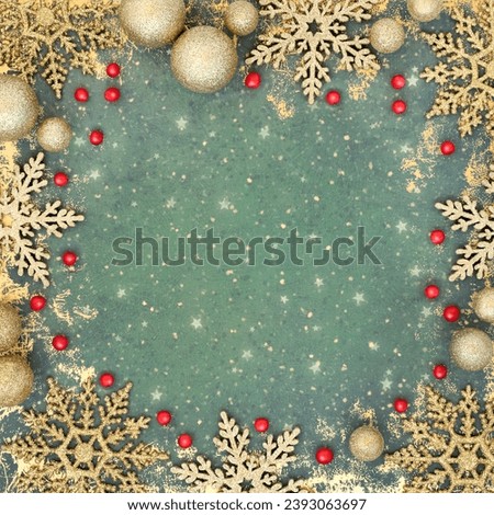 Christmas holly berry, gold snowflake and ball bauble decorations on grunge green background. Abstract festive design for greeting card, invitation, Yule, Noel.