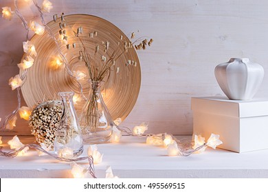 Christmas Home Decoration With Burning Lights On White Wooden Background. 