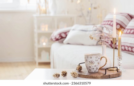 christmas home decorations with candles in white interior - Shutterstock ID 2366310579