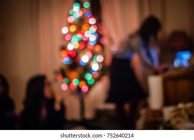 Christmas Home Party With Xmas Tree Light Decorated Looking For Music Playlist On Internet Isolated From Friend. Warm Or Sad Melancholy For Introvert Person Not Mixed In Crowd. Winter Night Background