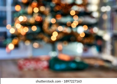 Christmas Home Room With Tree, Gifts And Festive Bokeh Lighting. Blurred Holiday Background.               