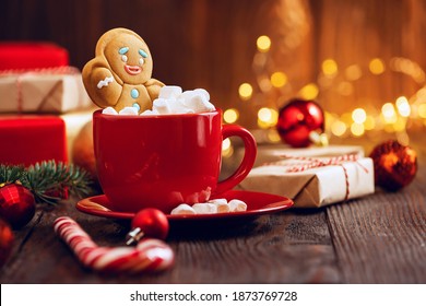 Christmas homemade gingerbread cookie and cup of hot chocolate with marshmallow on wooden table. Christmas food and drink concept - Powered by Shutterstock