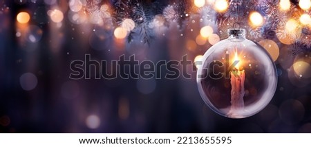 Christmas Hope - Candle With Bright Flame In Ball Hanging Tree With Defocused Lights On Background - Prayer And Advent Concept