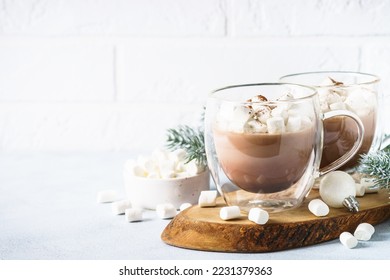 Christmas hot chocolate or cocoa with marshmallow on white with christmas decorations.