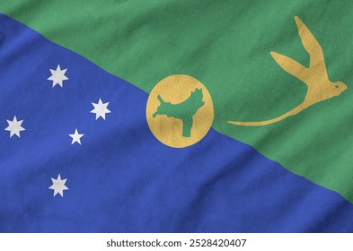 Christmas island flag depicted on folded wavy fabric of old cloth close up - Powered by Shutterstock