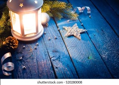 Christmas Lantern with decorations on blue wooden background. Studio shot