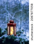 Christmas lantern and fir tree branches in snowy garden. winter nature background. magic atmosphere image. Christmas holiday. festive winter season.