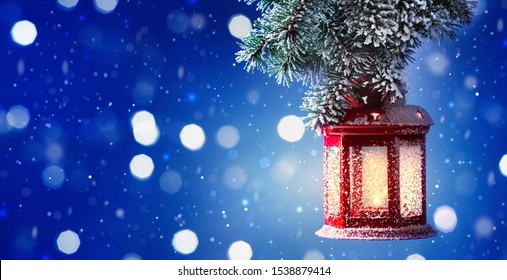 Christmas Lantern Hanging On Snow Covered Fir Branches. Winter Cozy Scene. Banner Format.