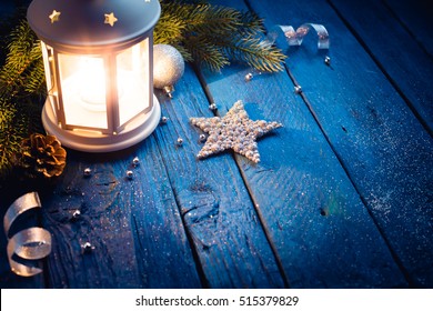 Christmas lantern in night on old blue wooden background - Shutterstock ID 515379829