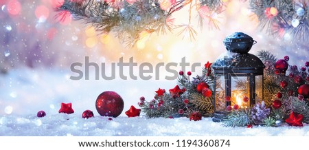  Christmas Lantern On Snow With Fir Branch in the Sunlight. Winter Decoration Background