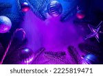 Christmas layout with christmas tree branches, christmas decorations in vibrant neon glow. copy space. top view. flat lay