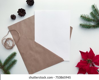 Christmas Letter To Santa Mockup, Flat Lay View Of White Wooden Desk With New-Year Ornaments And Craft Envelope