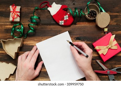 Christmas Letter Writing On White Paper On Wooden Background With Decorations