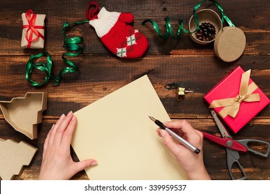 Christmas Letter Writing On Yellow Paper On Wooden Background With Decorations