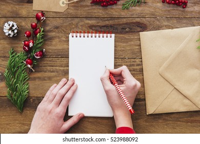 Christmas Letter Writing On Yellow Paper On Wooden Background With Decorations