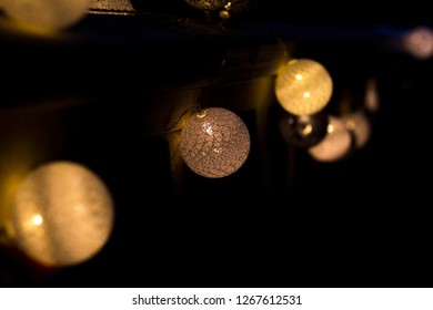 Christmas light balls as decoration on wooden railing. - Shutterstock ID 1267612531