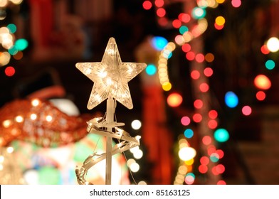 Christmas Lights Background. Nativity Star, Blurred Lights And Outdoor Decorations