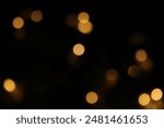Christmas lights in bokeh. Outside in December. Red and fire orange bokeh on a black background, bokeh abstract background, modern technological abstract background. Orange Christmas background, Xmas 