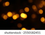 Christmas lights in bokeh. Outside in December. Red and fire orange bokeh on a black background, bokeh abstract background, modern technological abstract background. Orange Christmas background, Xmas
