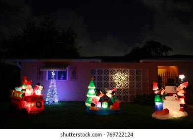 Christmas Lights And Decorations On Lawn In Front Of Small Home In Pompano Beach, Florida