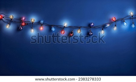 Christmas lights on dark blue background. Xmas holiday glowing garland.
