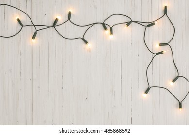 Christmas Lights On White Wooden Background