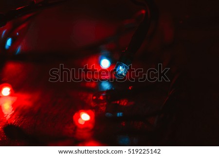 Christmas lights on wooden background.  Selective focus