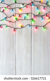 Christmas Lights Over White Painted Planks For Background