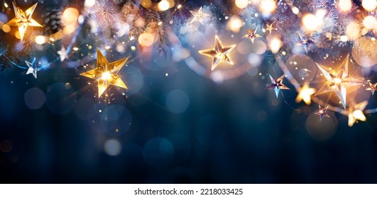 Christmas Lights - Stars String Hanging At Fir Branches In Abstract Defocused Background - Shutterstock ID 2218033425