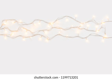 Christmas Lights In Warm Yellow White On String Over Light Background With Copy Space For Text, Logo Decoration On Xmas Eve Celebration, Special Holidays, New Year Event Concept