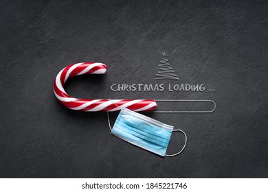 Christmas loading Concept - Candy cane on blackboard with christmas tree