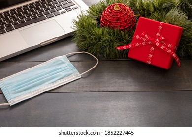 Christmas Lockdown, Office Closed, Covid 19 Pandemic. Protective Mask And Xmas Ornaments On Blue Wood Background, Business Desk Holiday Template, Copy Space