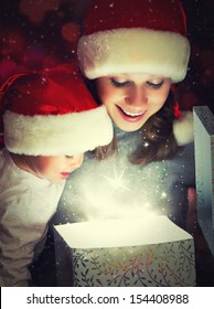 Christmas Magic Gift Box And A Woman Happy Family Mother And Child Baby