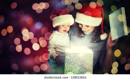 Christmas Magic Gift Box And A Woman Happy Family Mother And Child Baby