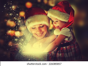 Christmas Magic Gift Box And A Woman Happy Family Mother And Daughter Baby Girl