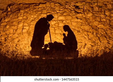 Christmas Man Nativity Scene Installation On Theme Of Birth Of Jesus Christ, Shadow And Silhouette. Street Decoration On The Eve Of Christmas