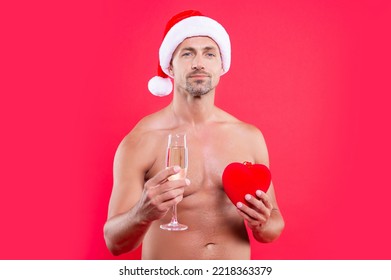 Christmas Man Portrait Isolated On Red Background. Man Hold Heart At Christmas In Studio.