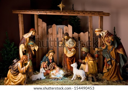 Christmas Manger scene with figurines including Jesus, Mary, Joseph, sheep and magi.