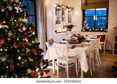 Christmas Meal Laid On Table In Decorated Dining Room.