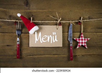 Christmas menu card for restaurants with knife and fork on wooden background with red white checkered stars. - Powered by Shutterstock