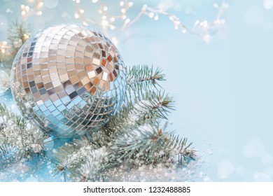 Christmas mirror evening bauble with fir tree and garland on pastel blue background. Holiday card with copy space. - Powered by Shutterstock