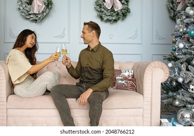 Christmas Mixed Race Couple Cheers Together Near Ornate Festive Eve. Holidays Celebrations Family Together