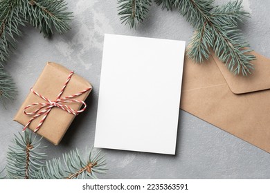 Christmas mockup with empty greeting card, fir tree branches and gift box - Powered by Shutterstock