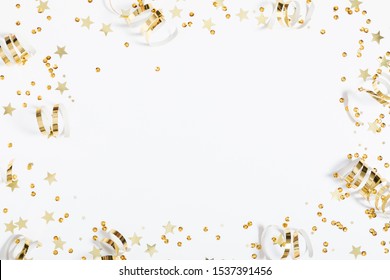 Christmas modern composition. Golden decorations, confetti, streamers, stars on white background. Christmas, New Year, winter concept. Flat lay, top view, copy space