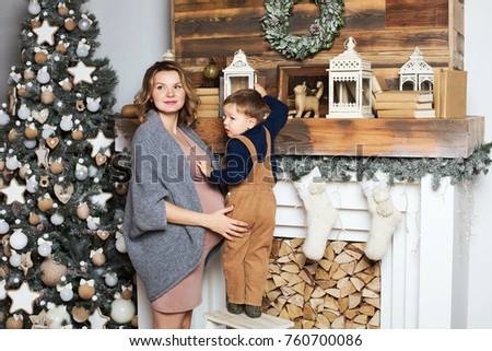 Christmas mood Mom and her son at the Christmas tree