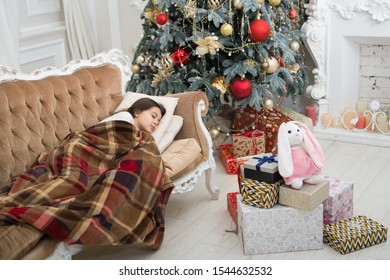 Christmas Morning. Happy New Year. Little Girl Sleep Couch Near Christmas Tree Classic Interior. Family Holiday. Christmas Tree And Presents. Dreaming About Gifts. Believe In Miracles. Magical Moment.