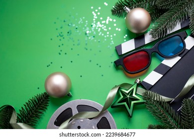 christmas movie night concept. New Year's decorations, film reel, clapperboard and confetti sparkles on a green background. creative new year layout with copy space. top view. flat lay - Powered by Shutterstock