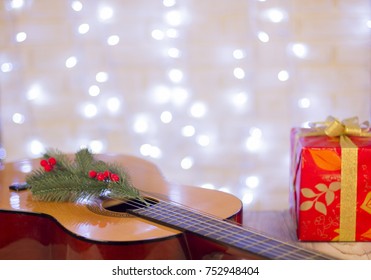 Christmas Music Background With Guitar And Red Gift