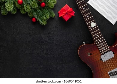 Christmas Music. Flat Lay Composition With Guitar And Fir Tree Branches 